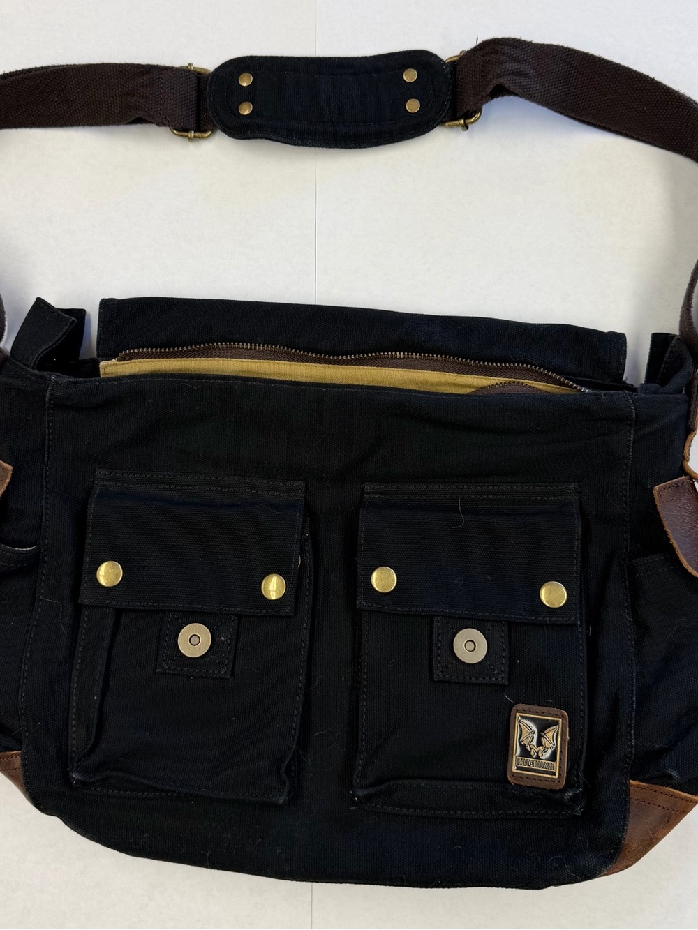 Black Canvas Messenger Bag with Dual Front Pockets and Brown Strap